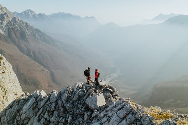 Hiking the Peaks of Theth, Albania - @edelweiss.on.the.road 06/2022 Thomas & Regina, from @edelweiss.on.the.road, are seen hiking the rugged peaks of Theth, Albania, surrounded by dramatic mountain views. This image captures a breathtaking moment during their vanlife adventure, exploring the remote and wild landscapes of the Albanian Alps.