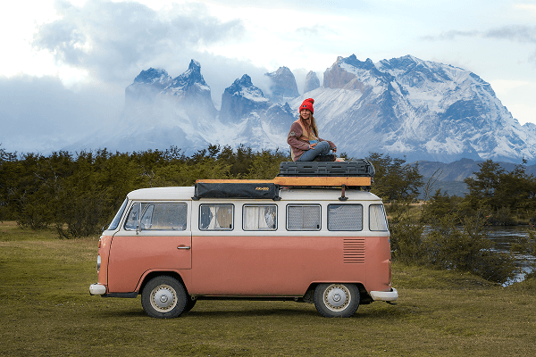 Victoria sitting on the roof of her VW T2 Kombi - @octaviaviajando 09/2022 Victoria known as @octaviaviajando on Instagram, sits on the roof of her pink and white 1985 Volkswagen T2 Kombi campervan named Octavia, parked in front of the dramatic snow-capped peaks of Torres del Paine in Patagonia. Captured during her solo vanlife journey from Atacama to Magallanes, this moment reflects her adventurous spirit, nomadic lifestyle, and dedication to sustainable travel and photography through Chile's wild landscapes.